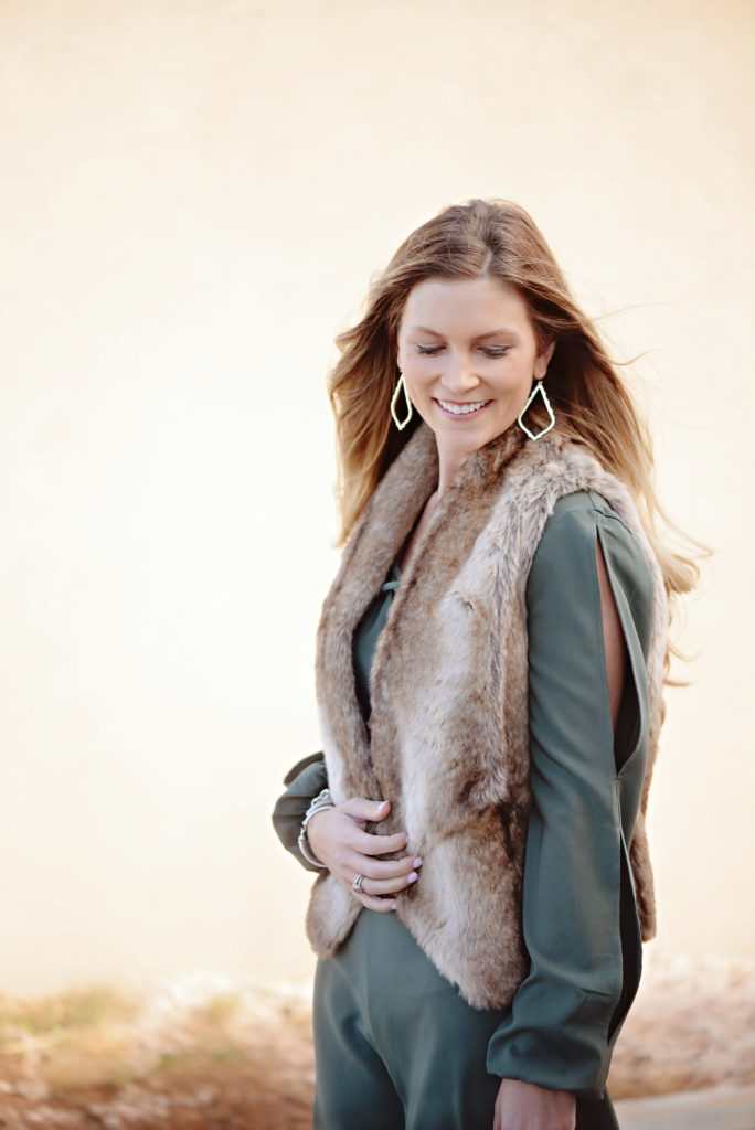How to wear a shorts romper in the winter by layering with a faux fur vest and jacket.