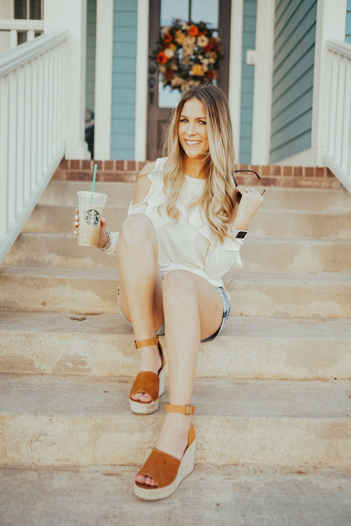 The easiest spring outfit to recreate! A lightweight top with cold shoulders, shorts that are long enough for moms but still trendy and a pair of sandals. Sandals are the dupes for Marc Fisher sandals but are $100 less! Get $10 off right now - Click through to see more, plus what my favorite #starbucks drinks are and what I'm currently listening to on my spring playlist! Visit https://ashleenichols.com// to read more!
